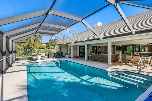 view of pool featuring a lanai, an outdoor living space, and a patio