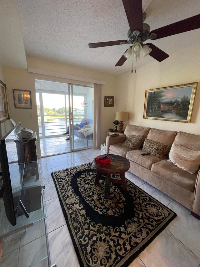 tiled living room with a textured ceiling and ceiling fan