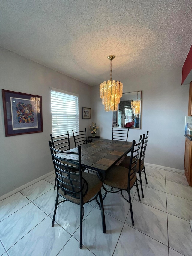 dining room with light tile patterned floors, a textured ceiling, and an inviting chandelier