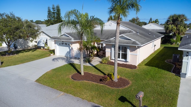 view of front facade with central AC unit, a garage, and a front lawn