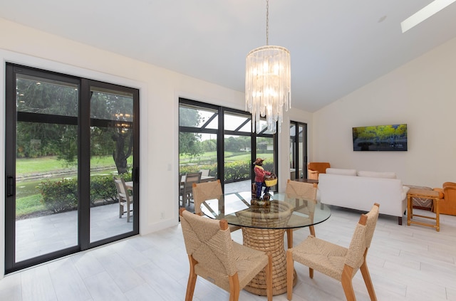 dining space featuring an inviting chandelier and vaulted ceiling