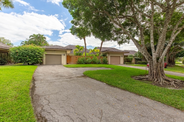 view of front of home featuring a front yard and a garage