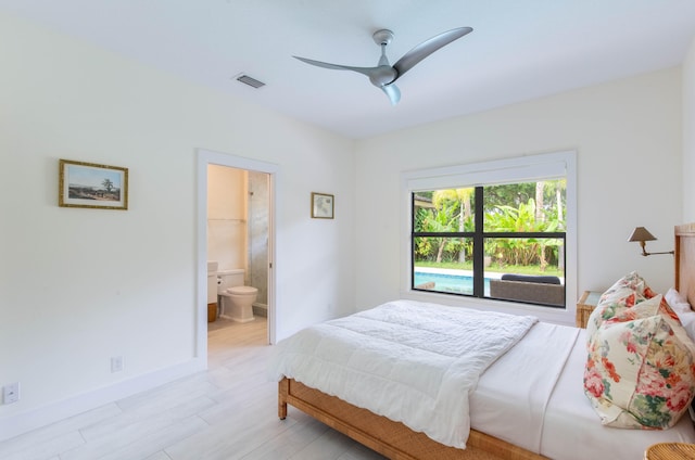 bedroom with light wood-type flooring, ensuite bath, and ceiling fan