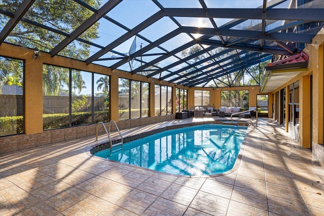 view of pool with a patio, glass enclosure, and an outdoor hangout area