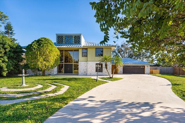 view of front facade with a front yard and a garage