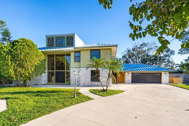 view of front of house with a front lawn and a garage