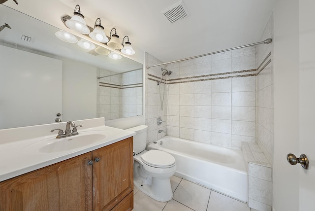 full bathroom featuring tile patterned floors, vanity, toilet, and tiled shower / bath