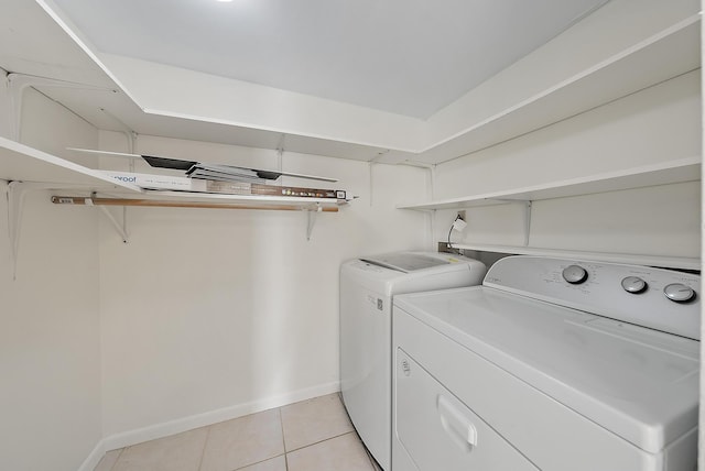 laundry room with separate washer and dryer and light tile patterned flooring