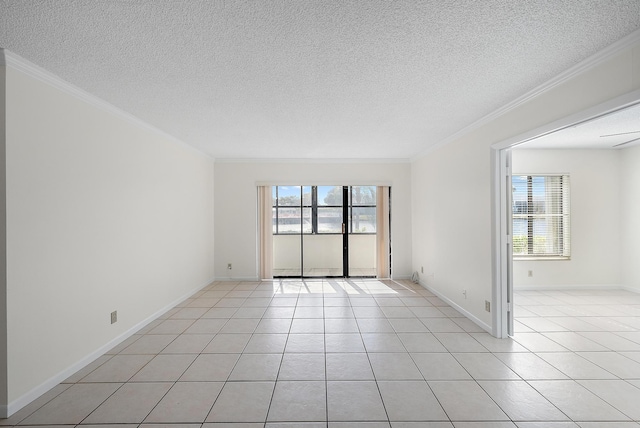 tiled spare room featuring a textured ceiling and ornamental molding