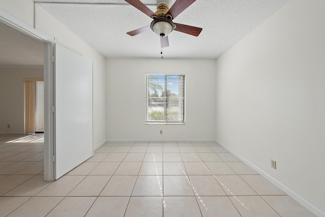 tiled empty room with a textured ceiling and ceiling fan