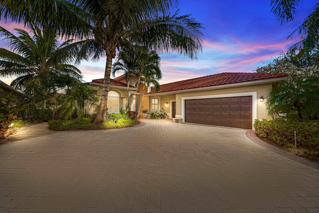 mediterranean / spanish-style house featuring a garage