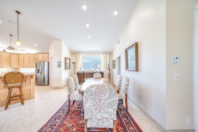 tiled dining area featuring lofted ceiling