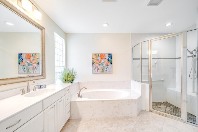 bathroom with vanity and independent shower and bath