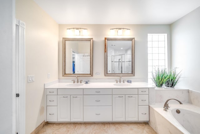 bathroom with plus walk in shower, vanity, and tile patterned floors