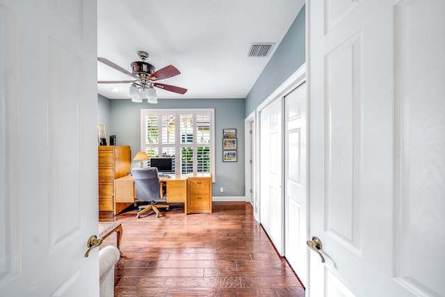 office space featuring hardwood / wood-style flooring, ceiling fan, and a textured ceiling