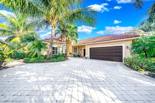 mediterranean / spanish house with a garage