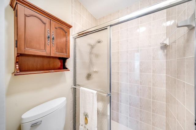 bathroom with walk in shower and toilet