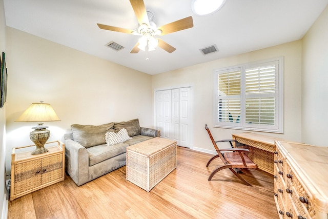 living room featuring ceiling fan and light wood-type flooring