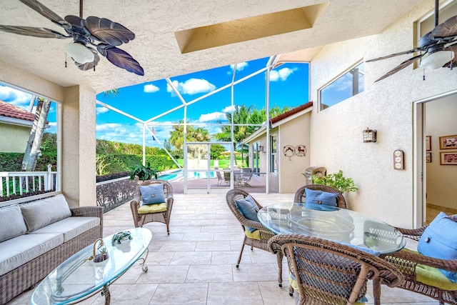 view of patio with outdoor lounge area, ceiling fan, and a lanai