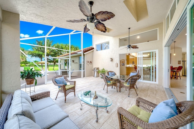 view of patio / terrace featuring an outdoor living space and glass enclosure