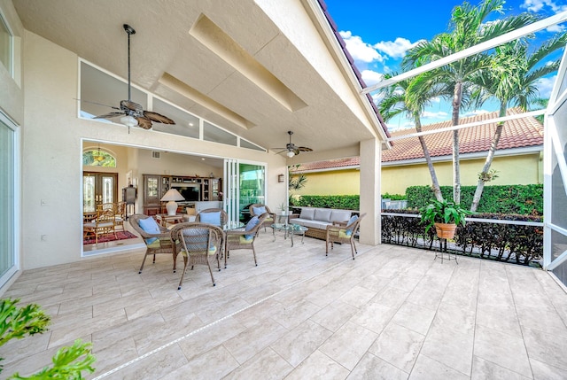 view of patio with a lanai, outdoor lounge area, and ceiling fan