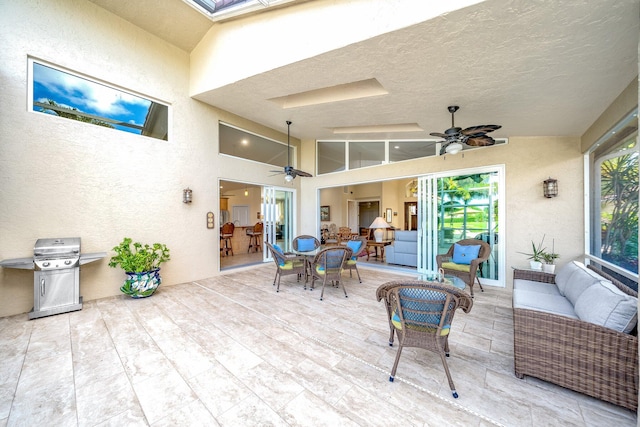 view of patio with outdoor lounge area, grilling area, and ceiling fan