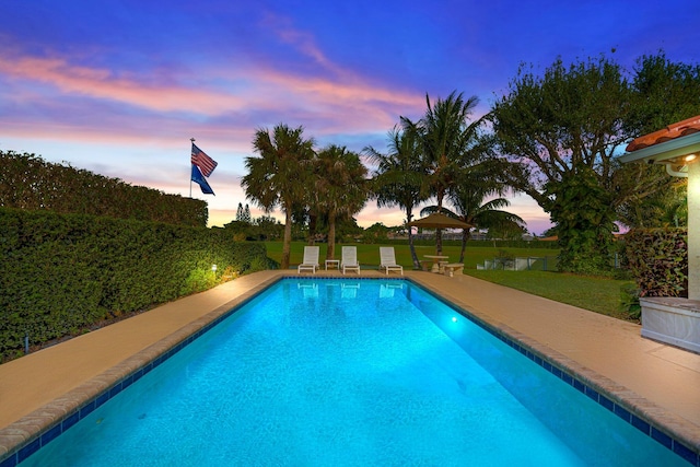 view of pool at dusk