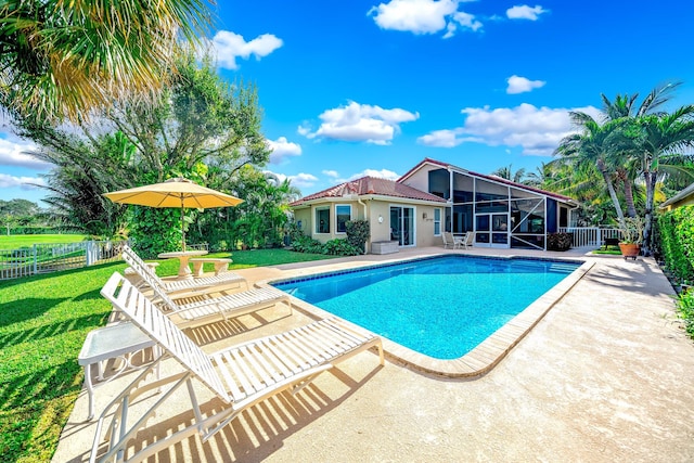 view of swimming pool with a lawn, a patio area, and a sunroom