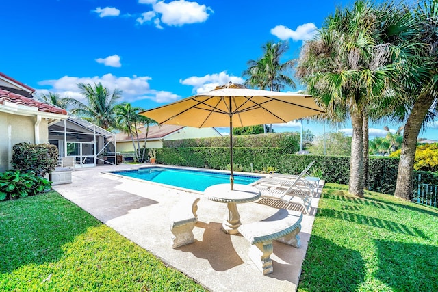 view of pool featuring a patio, a yard, and glass enclosure