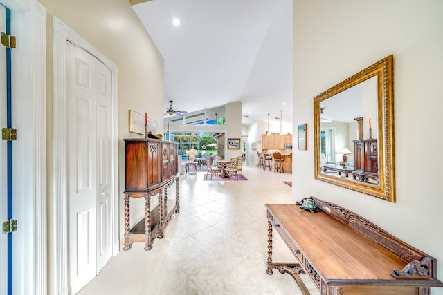 hall with light tile patterned floors and vaulted ceiling