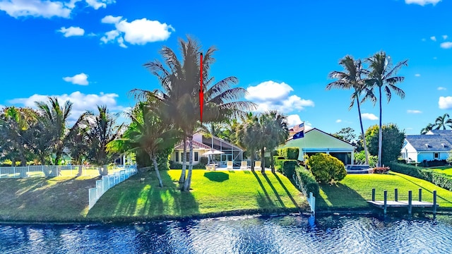 view of home's community featuring a lawn and a water view