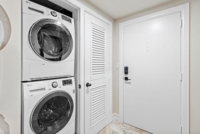 clothes washing area featuring stacked washer / drying machine