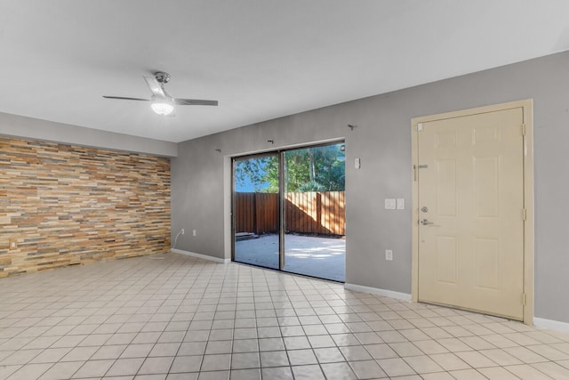 unfurnished room featuring ceiling fan and light tile patterned flooring