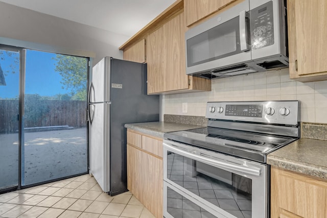 kitchen featuring appliances with stainless steel finishes, backsplash, light tile patterned floors, and light brown cabinets