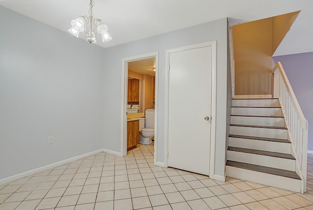 stairs with a chandelier