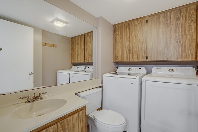 bathroom with washer and dryer and vanity