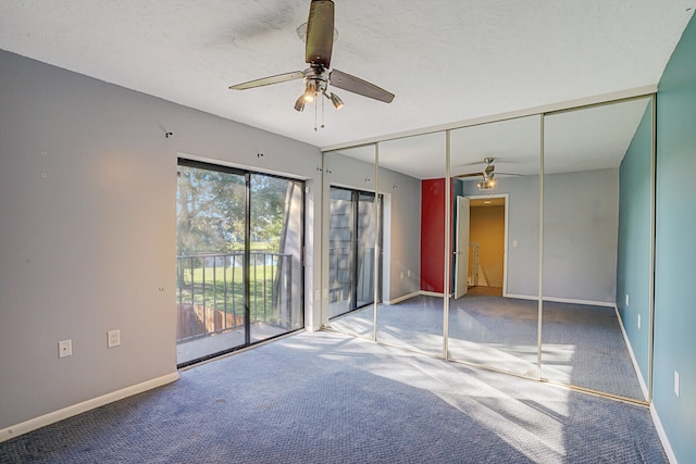 unfurnished bedroom featuring ceiling fan, carpet floors, a textured ceiling, access to outside, and a closet