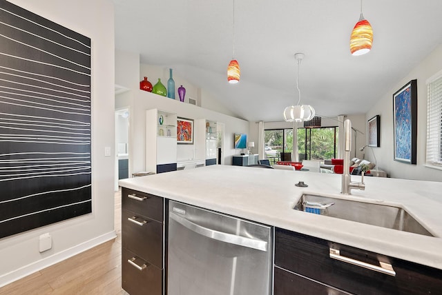 kitchen with sink, decorative light fixtures, dishwasher, light hardwood / wood-style floors, and lofted ceiling