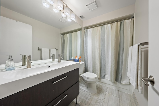 full bathroom with vanity, toilet, and shower / tub combo with curtain