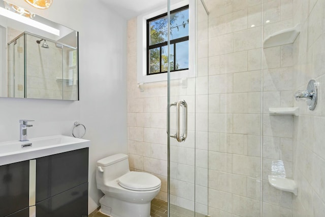 bathroom featuring tile patterned flooring, vanity, toilet, and an enclosed shower