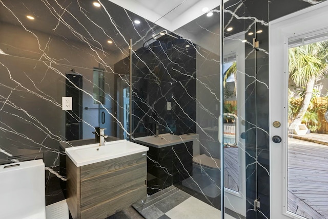 bathroom featuring vanity, toilet, and tile walls