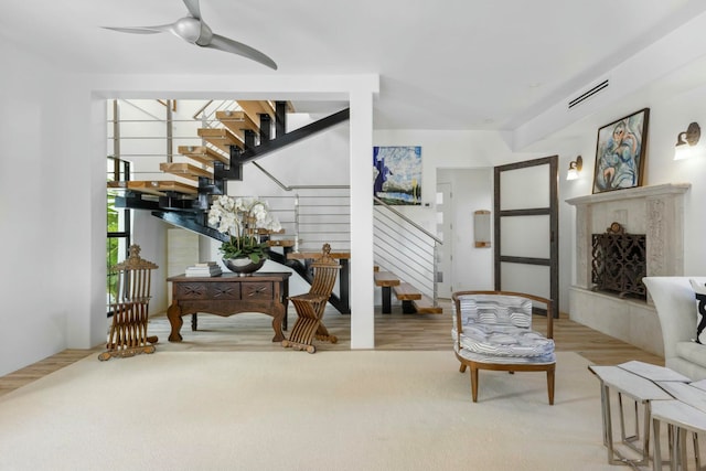 sitting room with ceiling fan and hardwood / wood-style flooring