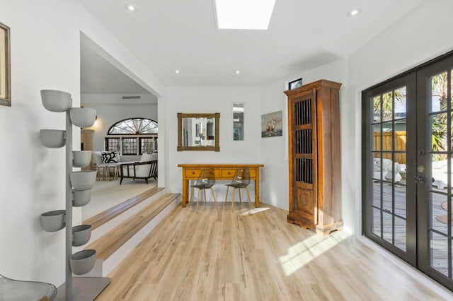 foyer entrance featuring french doors and light wood-type flooring