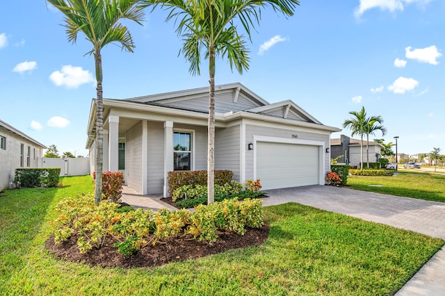 single story home featuring a front lawn and a garage