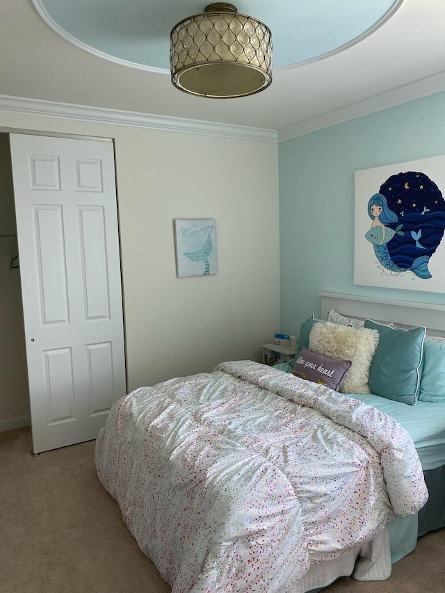 carpeted bedroom with ornamental molding and a closet