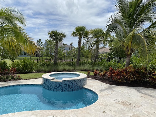 view of pool featuring an in ground hot tub