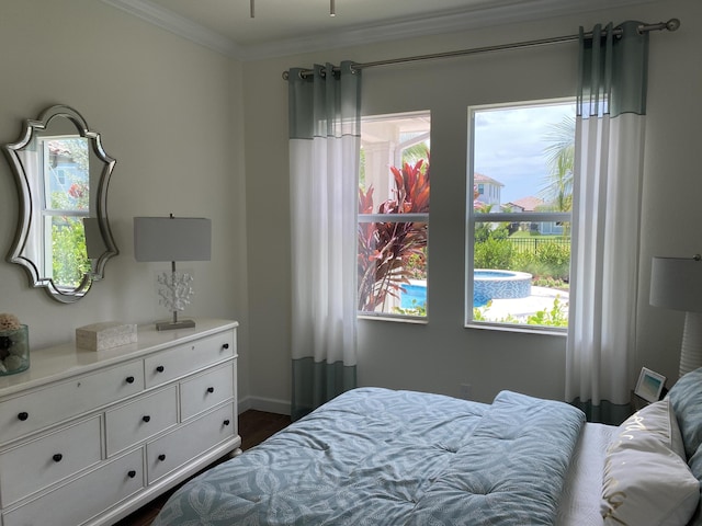 bedroom featuring crown molding and dark hardwood / wood-style floors