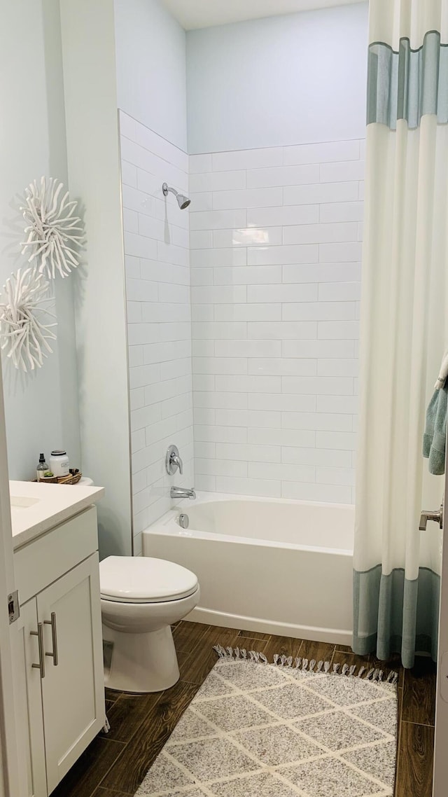 full bathroom with shower / bath combination with curtain, toilet, wood-type flooring, and vanity