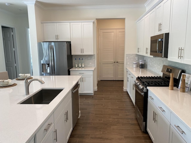 kitchen featuring white cabinets, stainless steel appliances, tasteful backsplash, and dark wood-type flooring