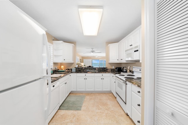 kitchen with ceiling fan, white cabinetry, dark stone countertops, and white appliances